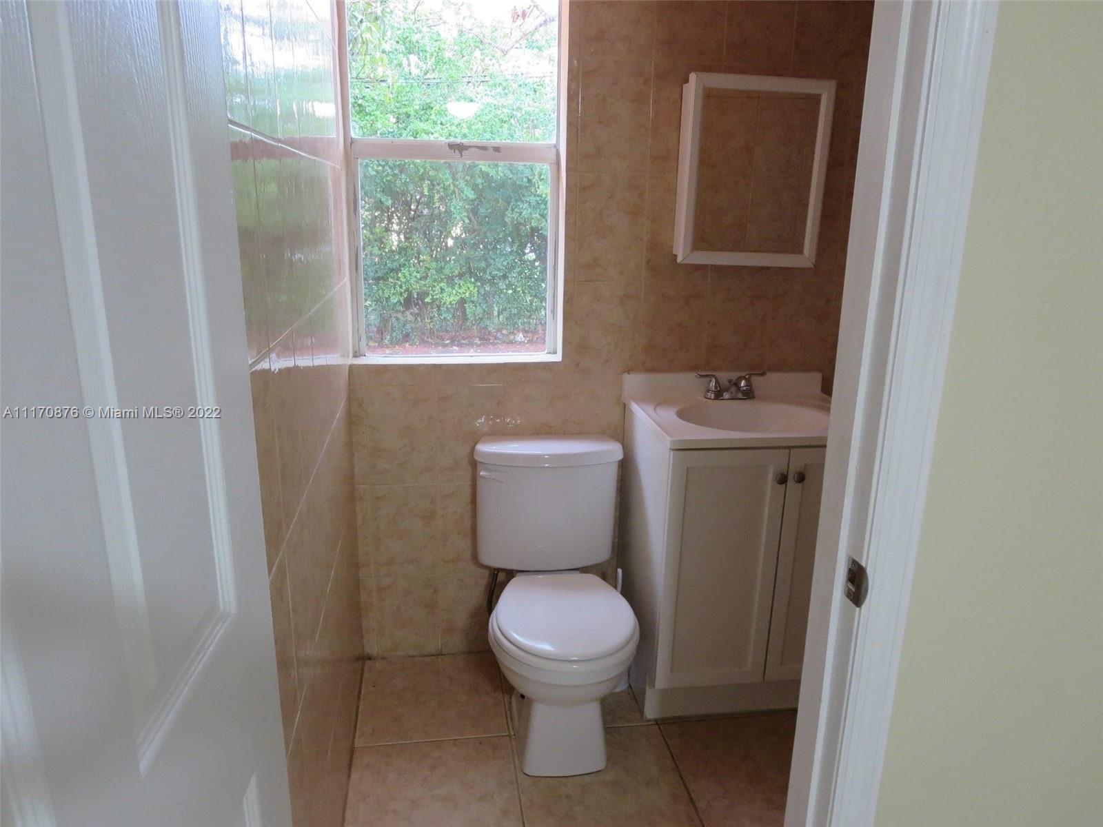 4001 Northwest 3rd Street Miami, FL 33126 - Photo 16 of 17 a bathroom with a toilet and a sink