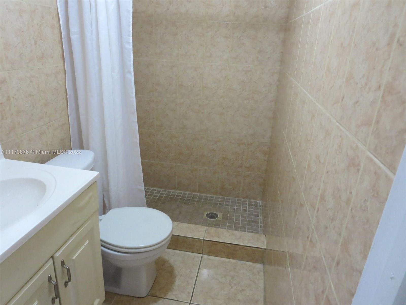 4001 Northwest 3rd Street Miami, FL 33126 - Photo 17 of 17 a white toilet sitting next to a shower