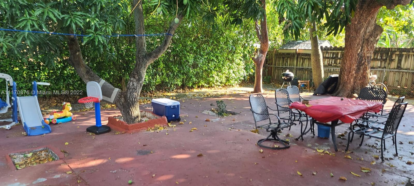 4001 Northwest 3rd Street Miami, FL 33126 - Photo 5 of 17 a view of a chairs and table in the backyard