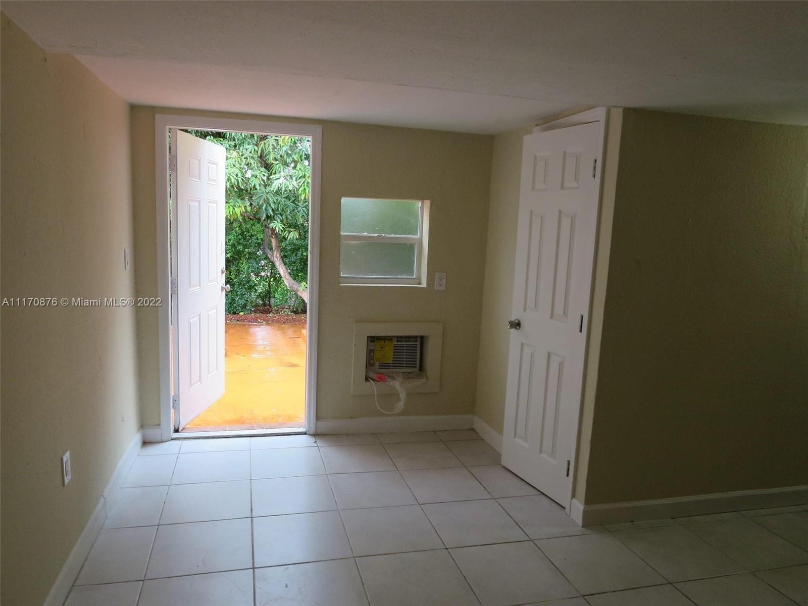 4001 Northwest 3rd Street Miami, FL 33126 - Photo 8 of 17 a view of an empty room with a window and fire place