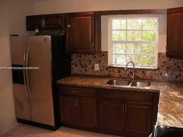 4001 Northwest 3rd Street Miami, FL 33126 - Photo 10 of 17 a kitchen with a sink and refrigerator