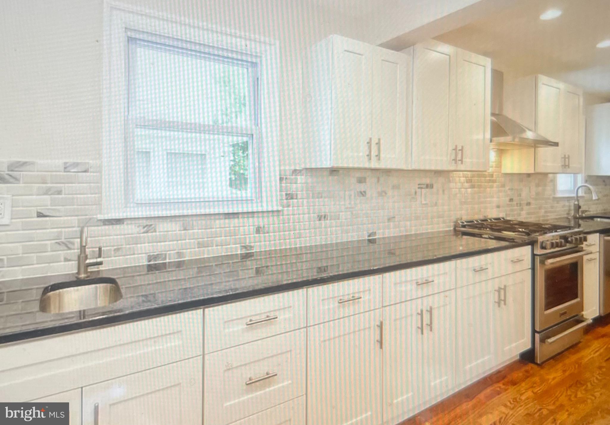 4001 State Road Upper Darby, PA 19026 - Photo 4 of 9 a kitchen with granite countertop white cabinets and stainless steel appliances