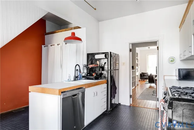 a kitchen with a stove and a refrigerator