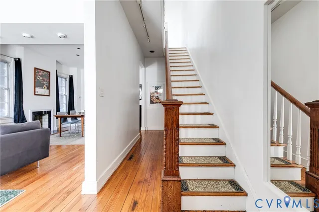 a view of entryway and hall with wooden floor