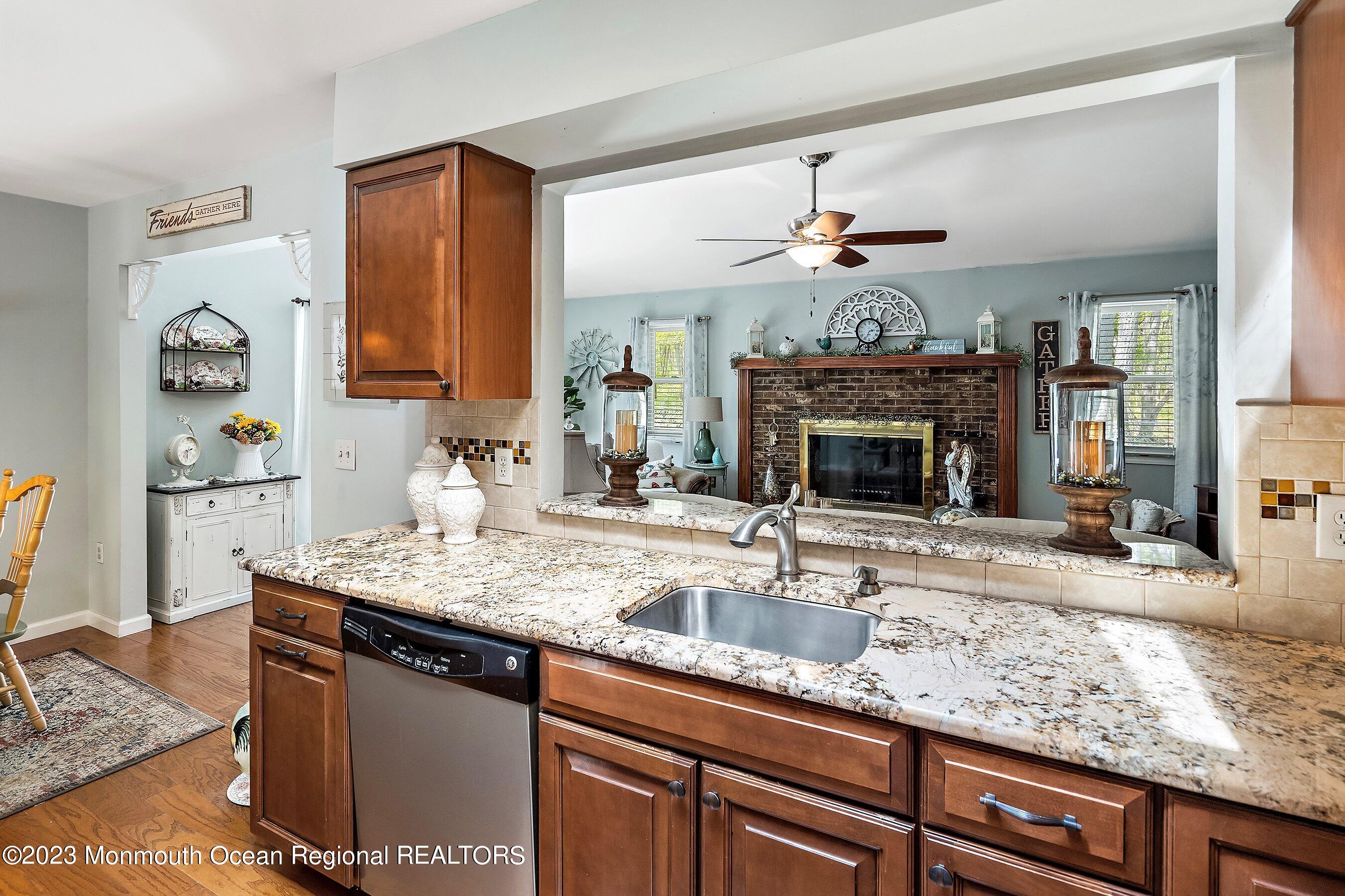 370 Constitution Drive Forked River, NJ 08731 - Photo 13 of 25 a kitchen with granite countertop a sink a counter top space and cabinets