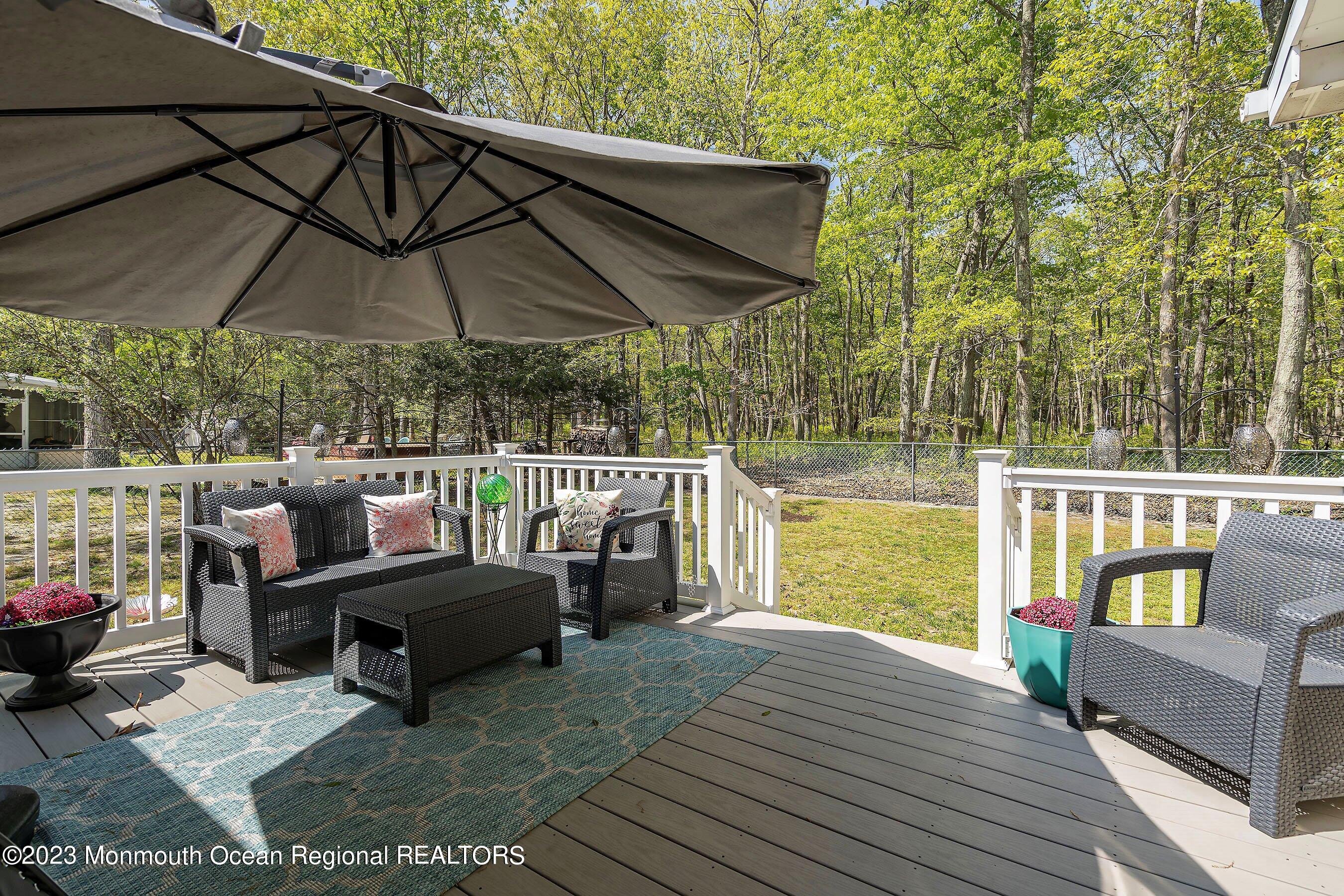 370 Constitution Drive Forked River, NJ 08731 - Photo 23 of 25 a view of a balcony with chairs and wooden floor
