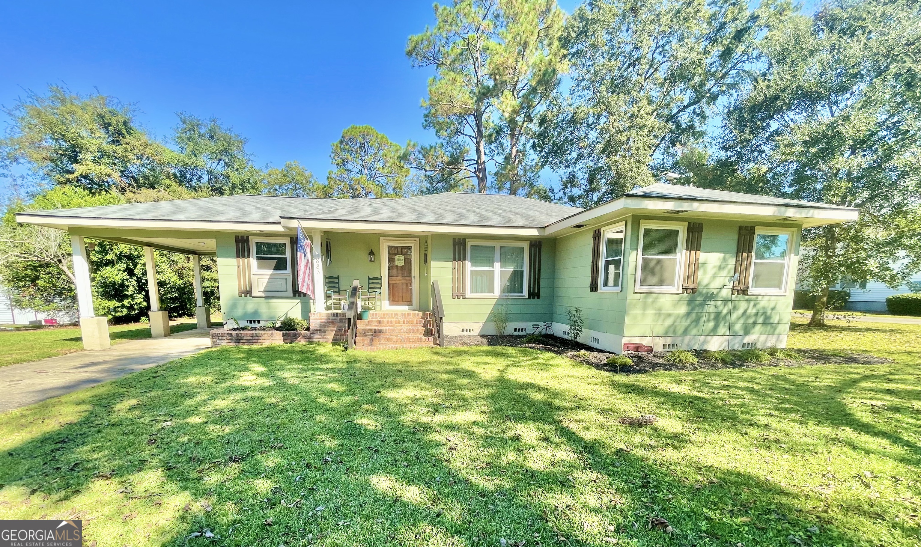 883 4th Avenue Rochelle, GA 31079 - Photo 2 of 34 a front view of a house with a yard table and chairs