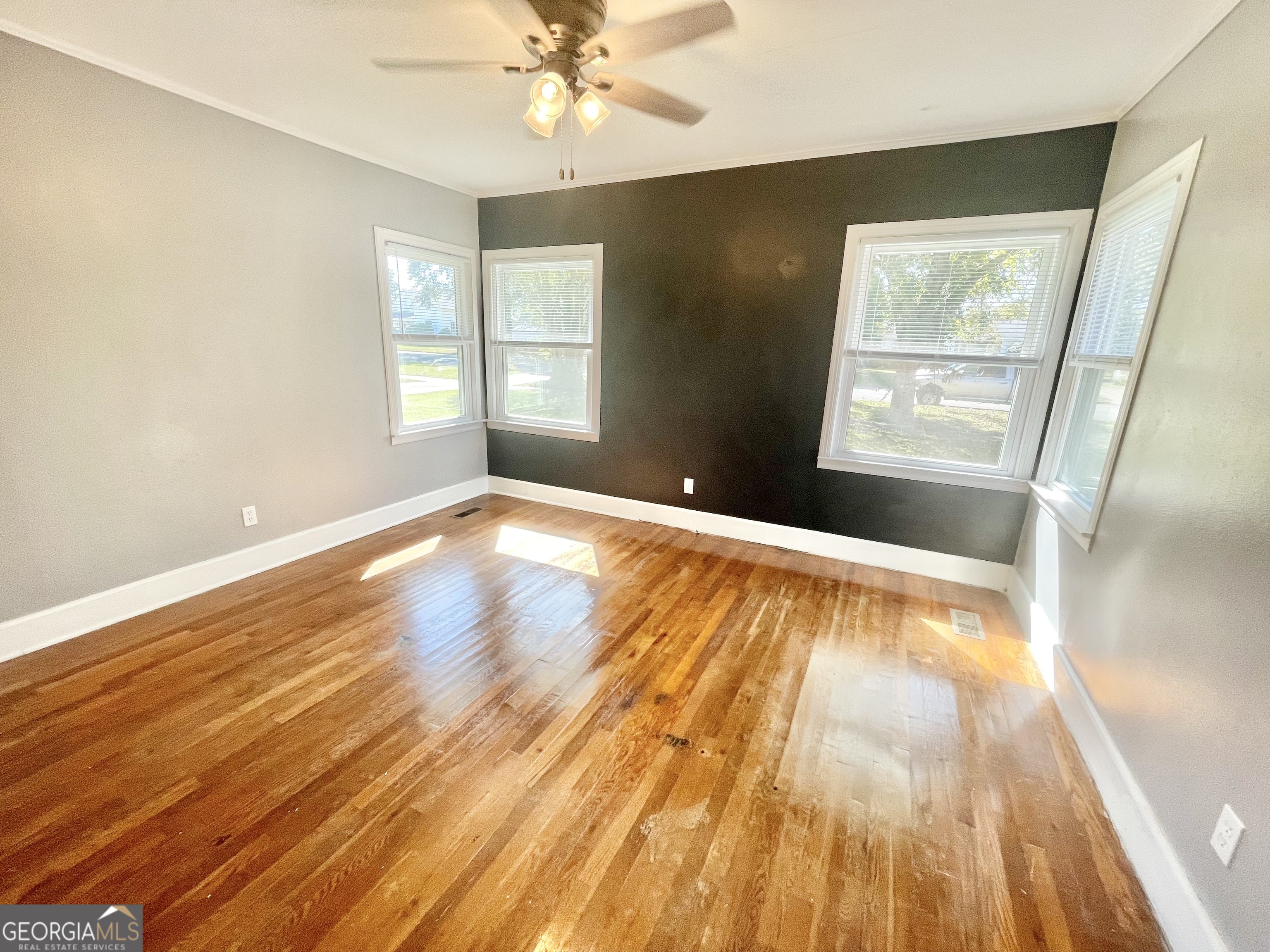 883 4th Avenue Rochelle, GA 31079 - Photo 21 of 34 a view of an empty room with wooden floor and a window