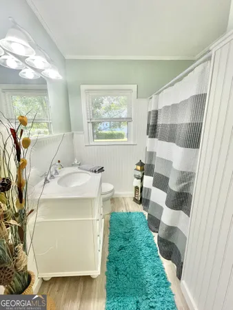 a spacious bathroom with a sink and mirror with bathtub