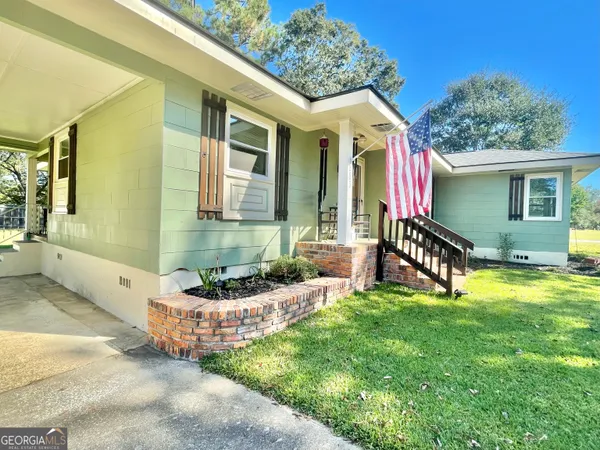 a front view of house with yard and outdoor seating
