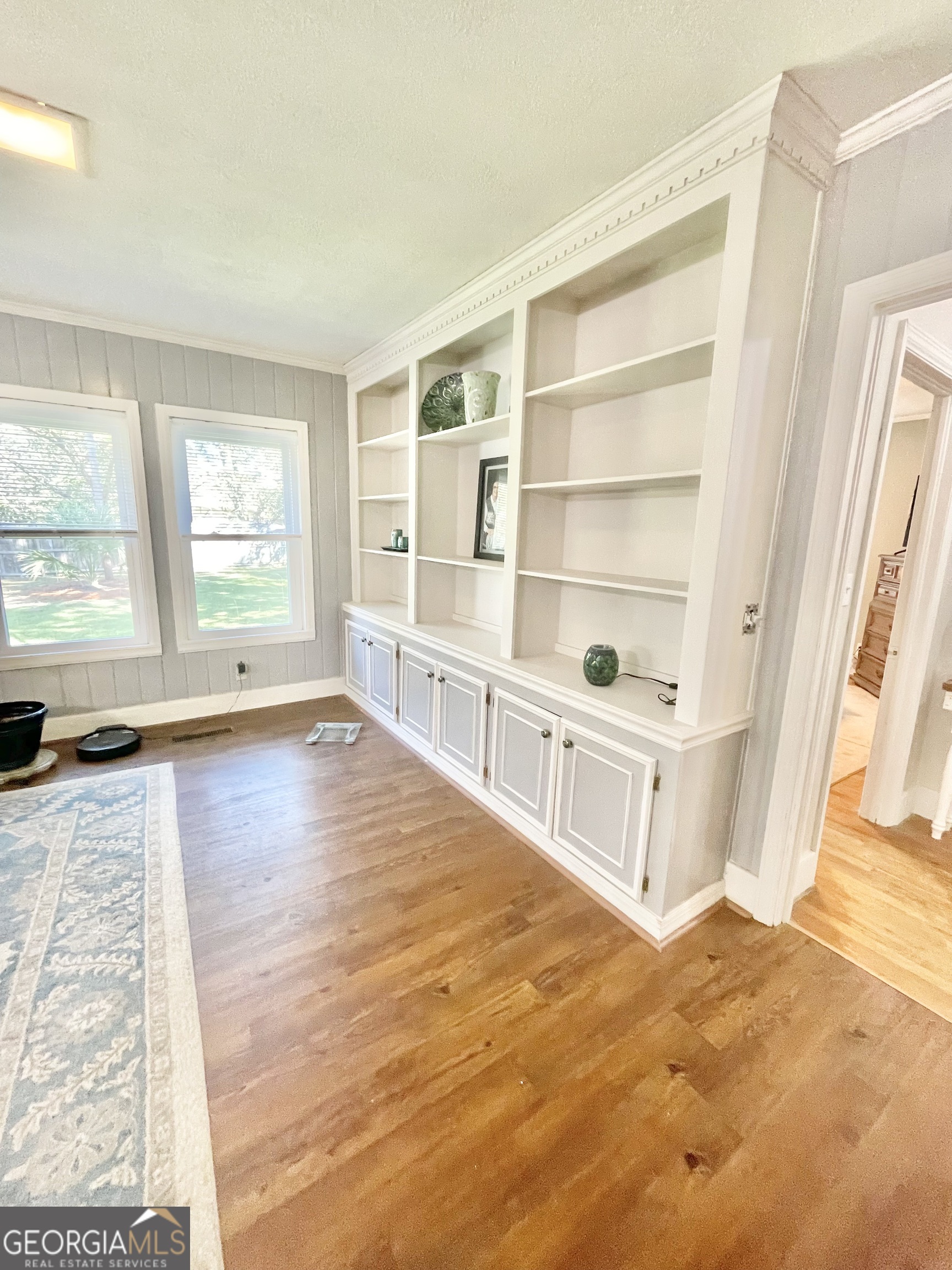 883 4th Avenue Rochelle, GA 31079 - Photo 10 of 34 a view of an empty room with wooden floor and a window