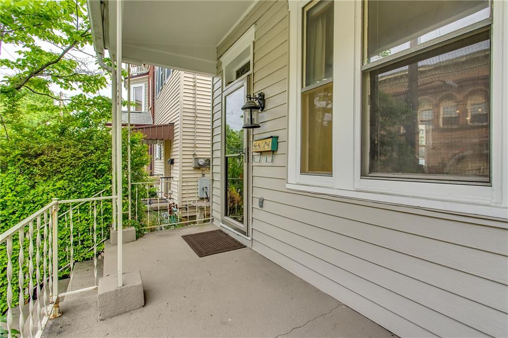 705 Filbert Street Pittsburgh, PA 15232 - Photo 2 of 25 Looking at the front door from the porch. Notice, an outdoor electrical outlet to hang some string lights if desired for decoration.