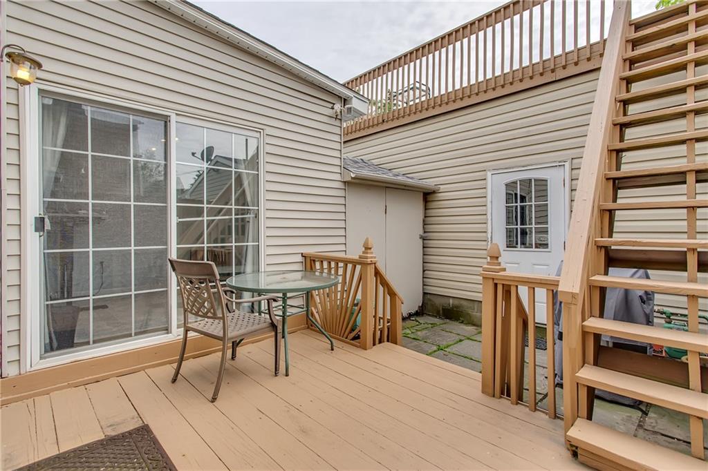 705 Filbert Street Pittsburgh, PA 15232 - Photo 23 of 25 The sliding door you see goes to the den. There is a storage shed between the den and the garage. The staircase goes up to the roof top HUGE deck above the garage. This area is very private!