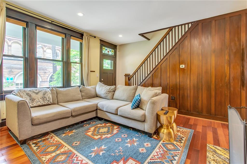 705 Filbert Street Pittsburgh, PA 15232 - Photo 5 of 25 Sun-filled living room is spacious, has a coat closet and a gas-log fireplace. The sellers have not used it, so are considering it decorative.