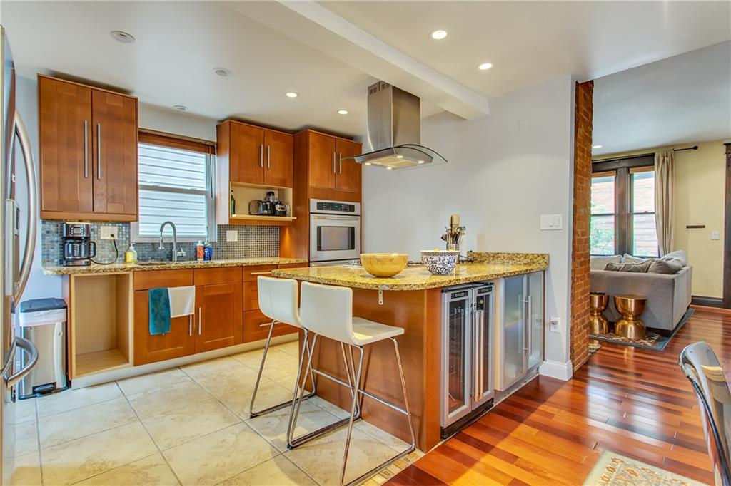 705 Filbert Street Pittsburgh, PA 15232 - Photo 10 of 25 Huge ceramic tiles on the floors complement the granite counter tops and the mosaic back splash. What a great space for entertaining!