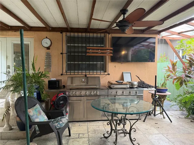 a front view of house with outdoor seating and plants