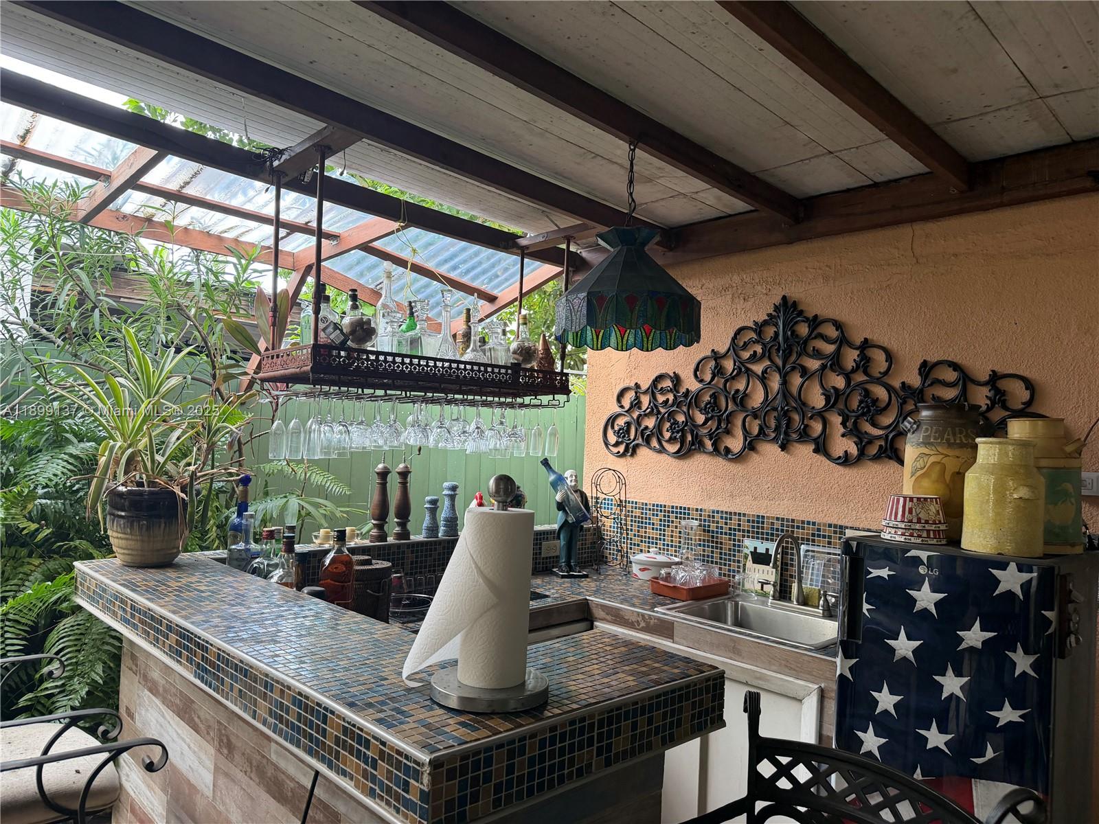 901 Southwest 19th Avenue Miami, FL 33135 - Photo 12 of 60 a table with wine bottles and glasses on it