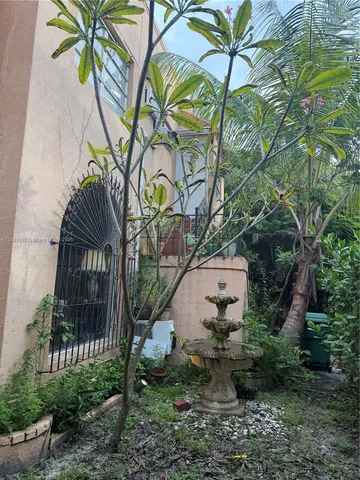 a view of a dining room with furniture a rug and wooden floor