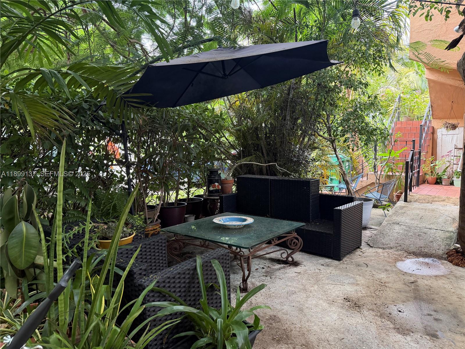 901 Southwest 19th Avenue Miami, FL 33135 - Photo 2 of 60 a backyard of a house with table and chairs a barbeque with a fire pit