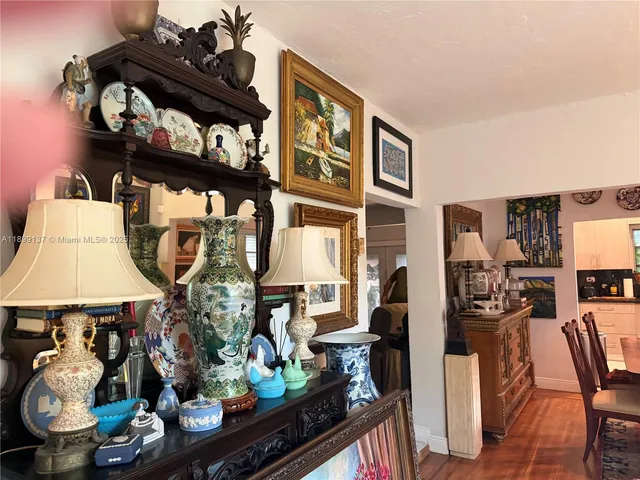 a living room with furniture and a wall painting