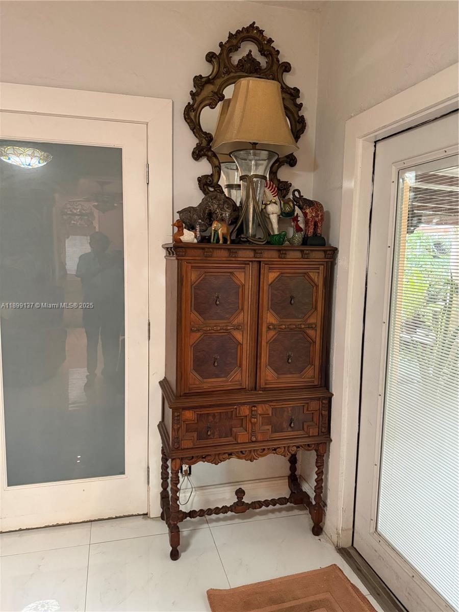 901 Southwest 19th Avenue Miami, FL 33135 - Photo 49 of 60 a room with painting on the wall and a mirror