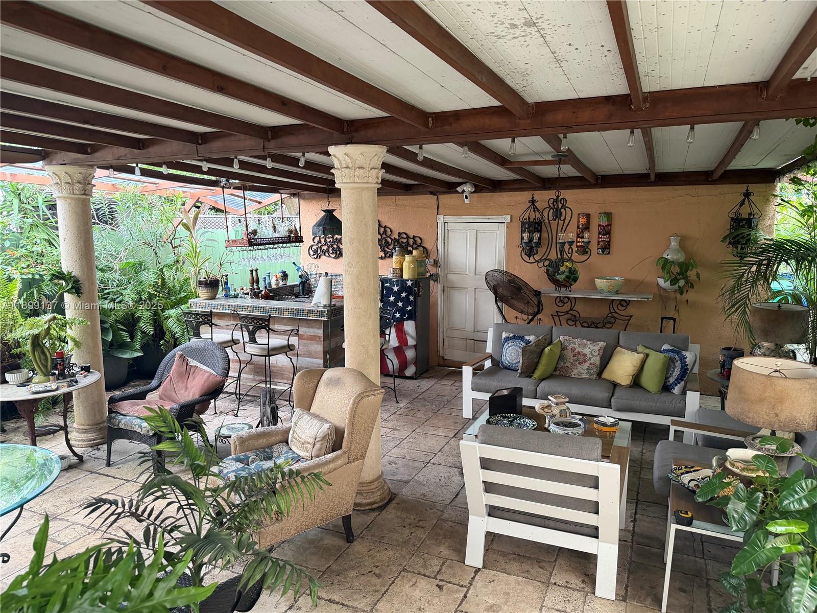 901 Southwest 19th Avenue Miami, FL 33135 - Photo 52 of 60 a view of a patio with table and chairs and potted plants