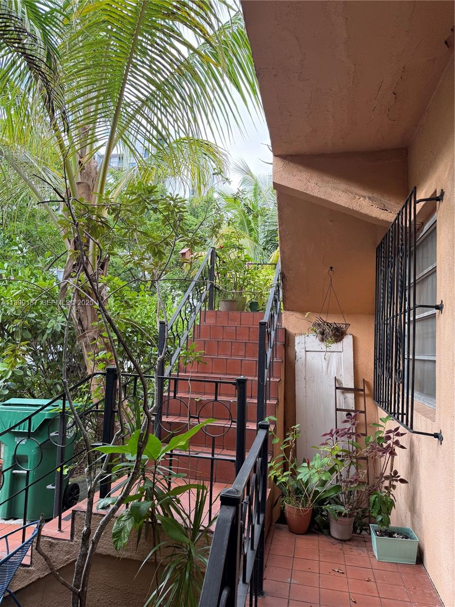 901 Southwest 19th Avenue Miami, FL 33135 - Photo 53 of 60 a backyard of a house with table and chairs potted plants