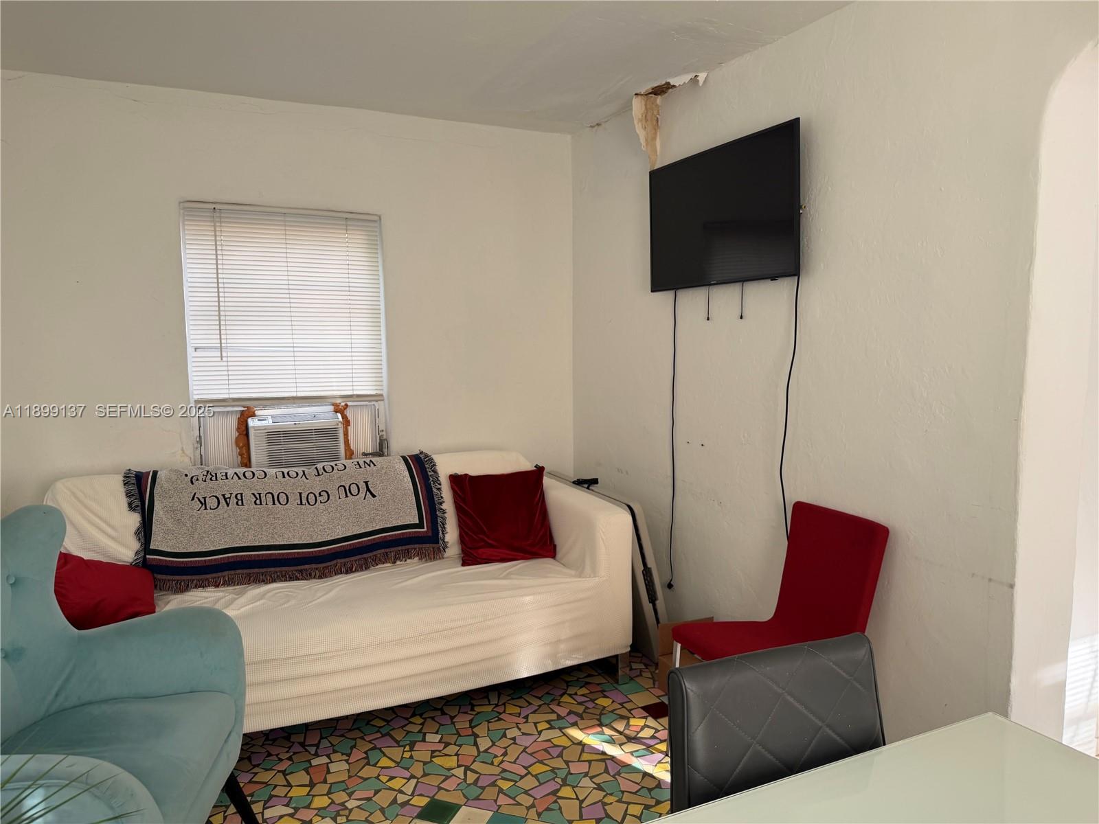 901 Southwest 19th Avenue Miami, FL 33135 - Photo 55 of 60 a living room with furniture and a flat screen tv