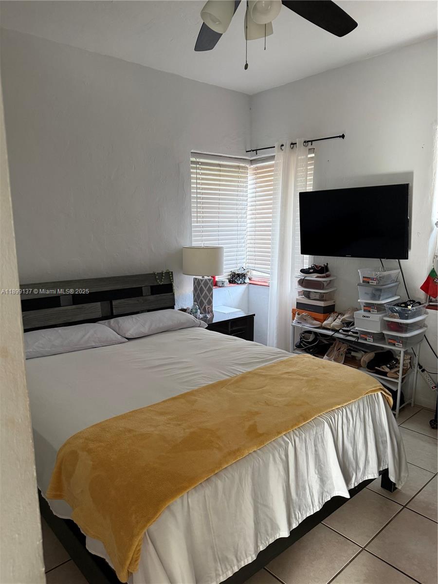 901 Southwest 19th Avenue Miami, FL 33135 - Photo 57 of 60 a bedroom with a bed and a flat screen tv
