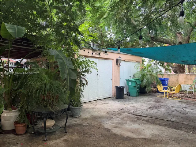 a yellow plant sitting in front of a house
