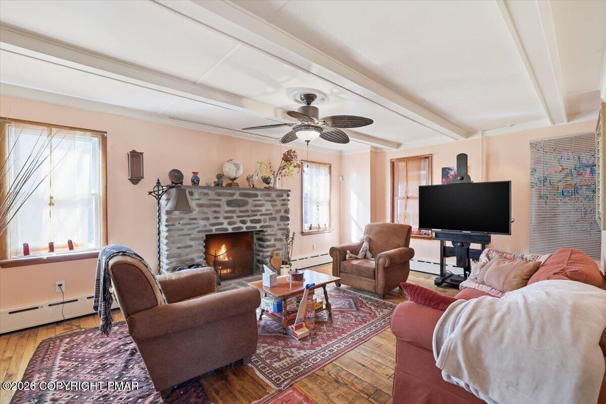 2487 Mountain Road Stroudsburg, PA 18360 - Photo 23 of 61 a living room with furniture a fireplace and a flat screen tv