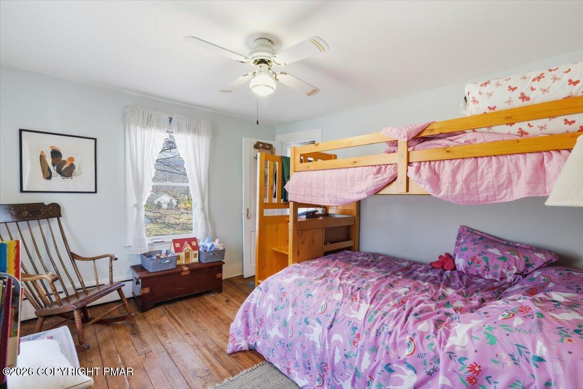 2487 Mountain Road Stroudsburg, PA 18360 - Photo 31 of 61 a bedroom with a bed and wooden floor
