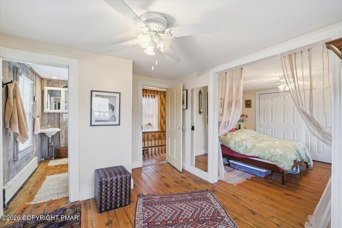 2487 Mountain Road Stroudsburg, PA 18360 - Photo 38 of 61 a bedroom with a bed and wooden floor