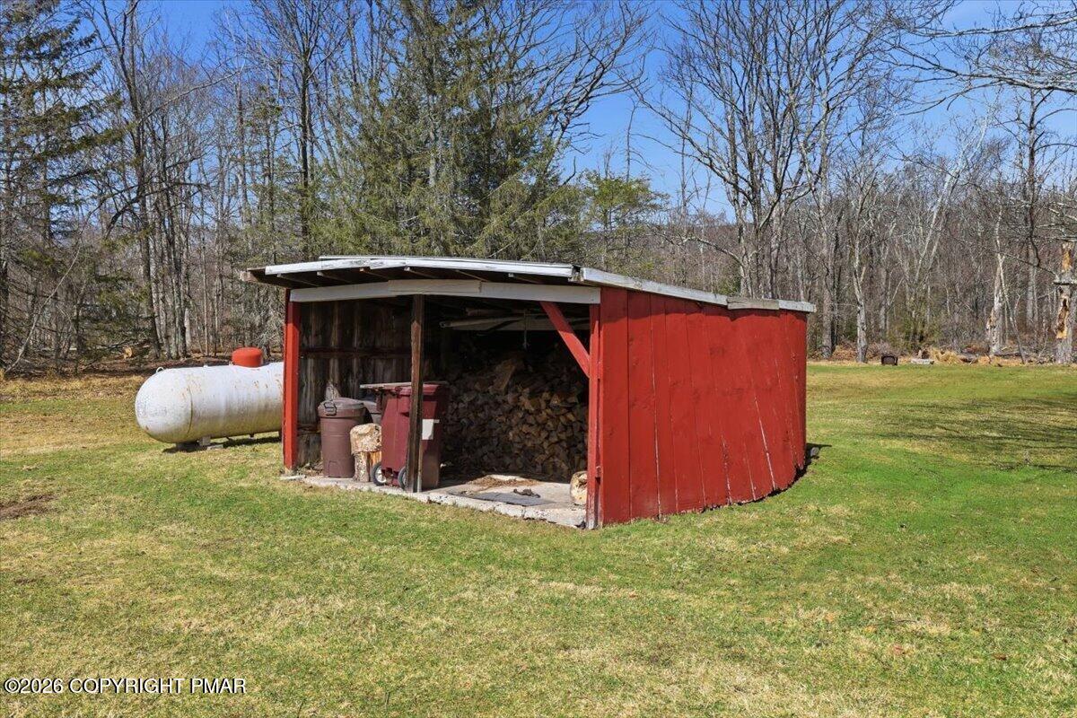 2487 Mountain Road Stroudsburg, PA 18360 - Photo 51 of 61 a view of a backyard with a barn and a large tree