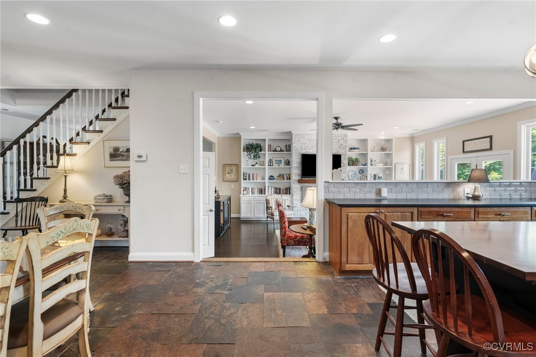 4060 Foxrun Road Powhatan, VA 23139 - Photo 15 of 50 a kitchen with stainless steel appliances kitchen island granite countertop a table chairs sink and cabinets