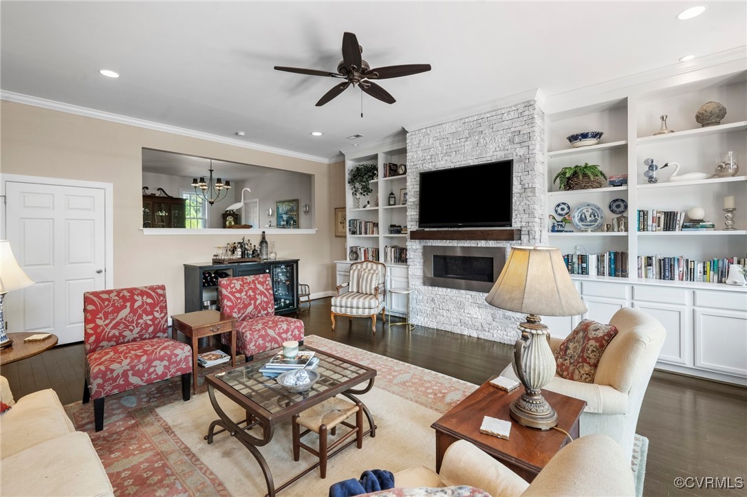 4060 Foxrun Road Powhatan, VA 23139 - Photo 18 of 50 a living room with furniture a flat screen tv and a fireplace