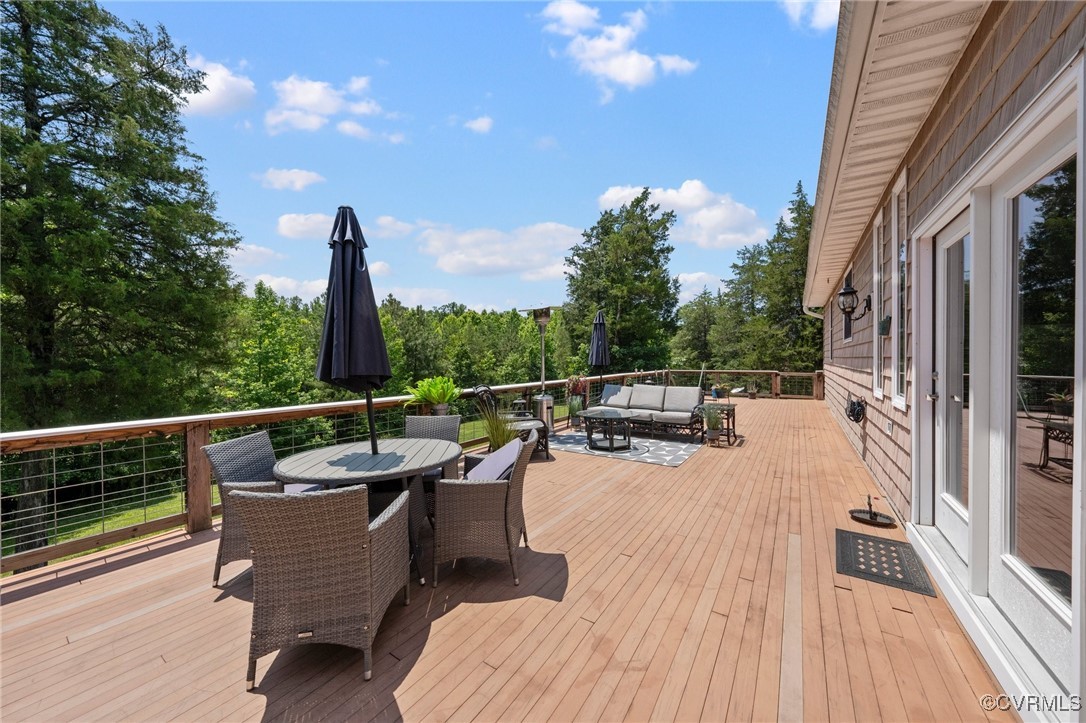 4060 Foxrun Road Powhatan, VA 23139 - Photo 27 of 50 a roof deck with table and chairs and wooden floor