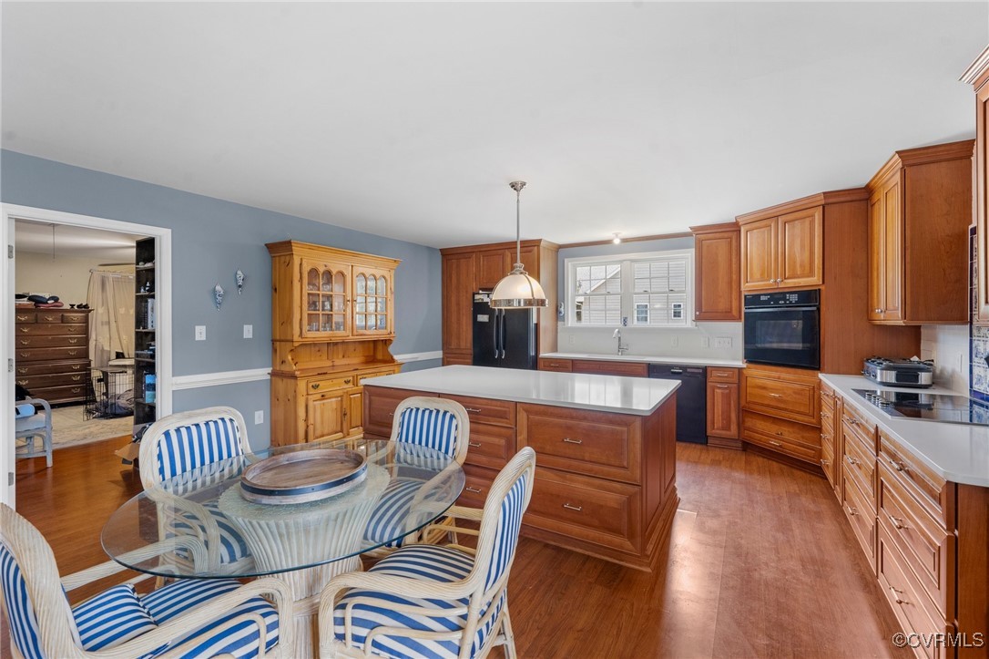 4060 Foxrun Road Powhatan, VA 23139 - Photo 40 of 50 a kitchen with a table chairs stove and wooden floor