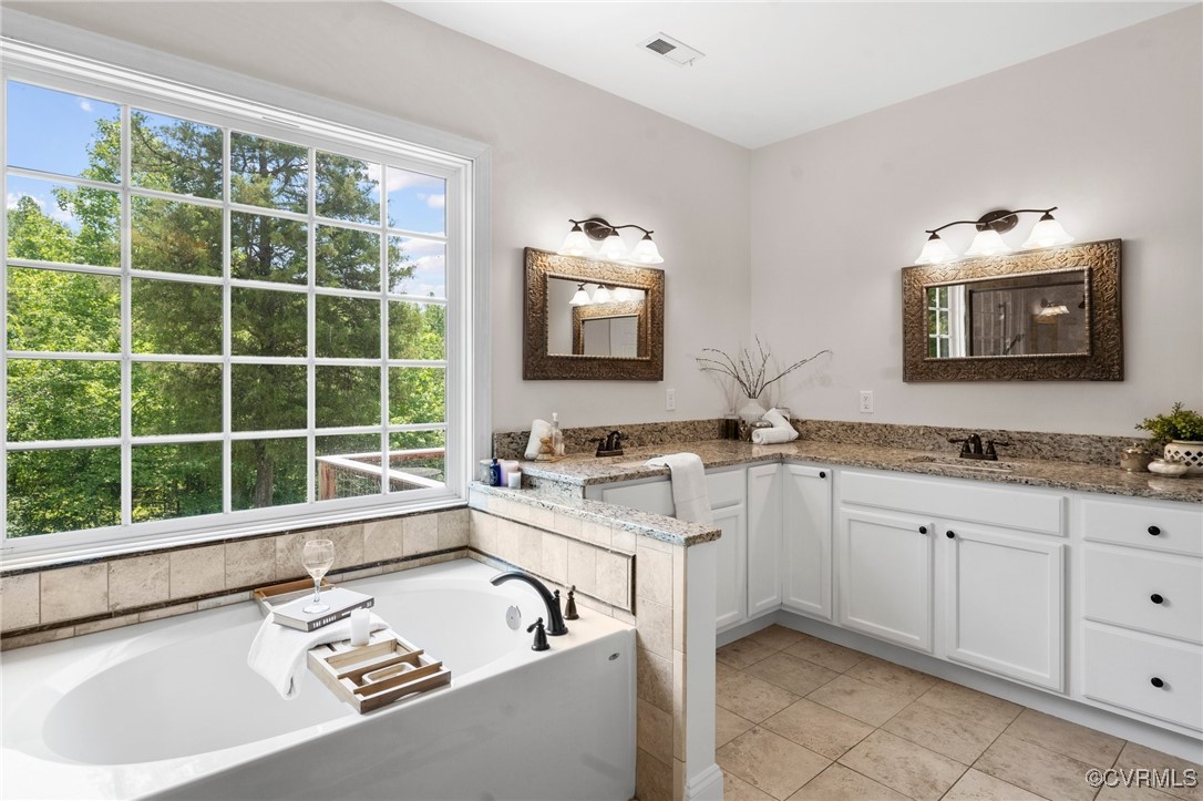 4060 Foxrun Road Powhatan, VA 23139 - Photo 9 of 50 a bathroom with a tub sink and mirror