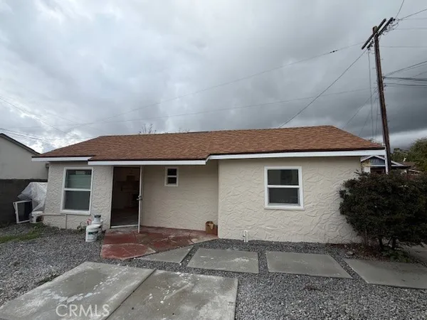 a backyard of a house with potted plants