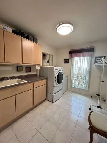a kitchen with a sink cabinets and window