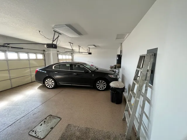 a roof deck with table and chairs