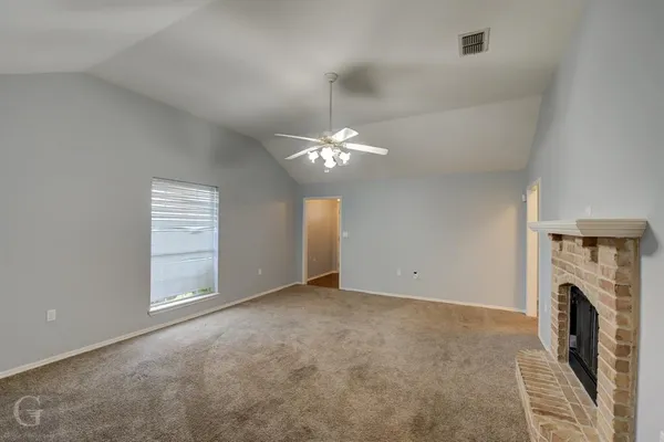 wooden floor in an empty room with a fireplace