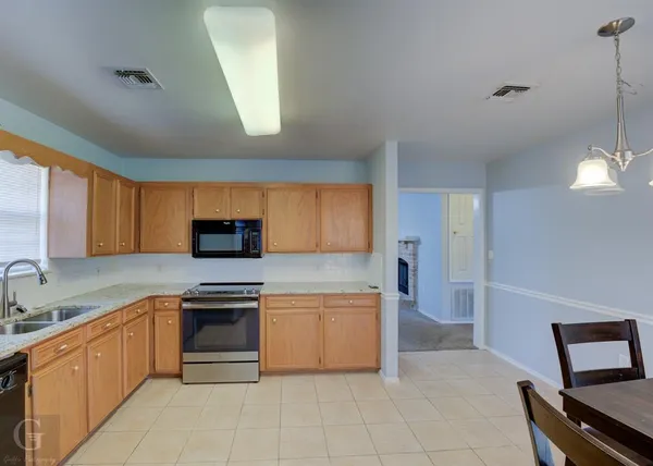 a kitchen with a stove a sink and a refrigerator