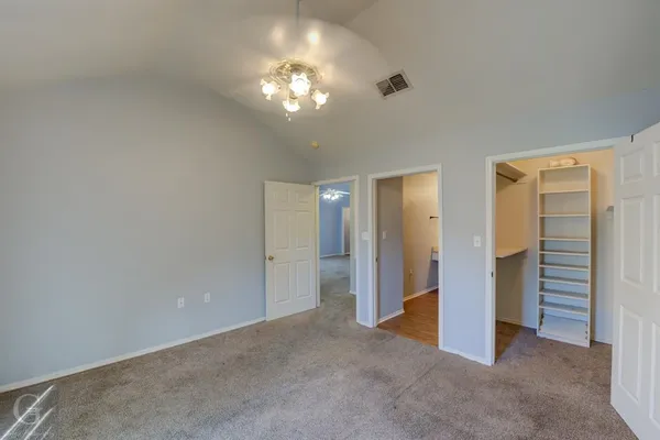 a view of a hallway with chandelier