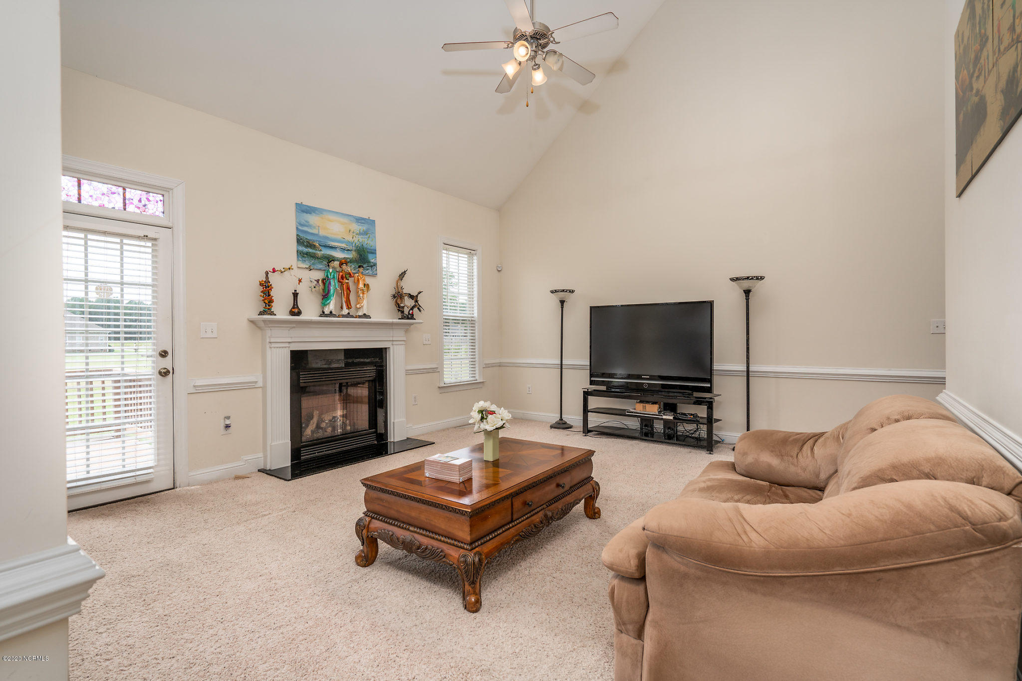 5959 Sandford Road Wilson, NC 27896 - Photo 6 of 36 Cathedral ceilings in the living room with Gas logs and frenchdoor to back deck