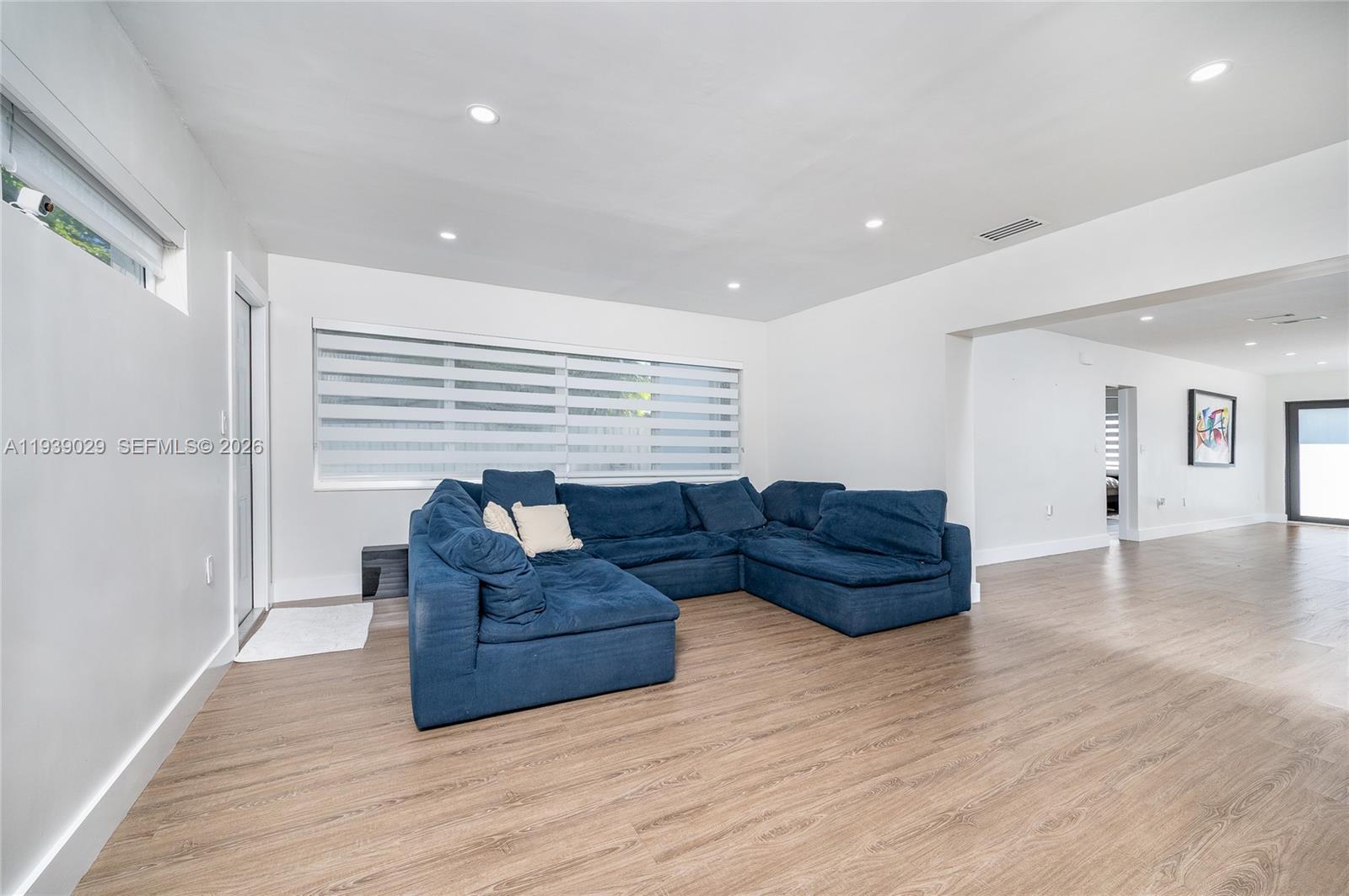 3077 Southwest 5th Street Miami, FL 33135 - Photo 13 of 25 a living room with furniture and a wooden floor