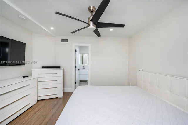 a bedroom with a bed and flat screen tv