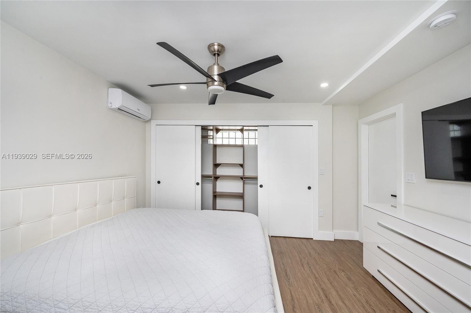 3077 Southwest 5th Street Miami, FL 33135 - Photo 18 of 25 a bedroom with a bed and a flat tv screen on dresser