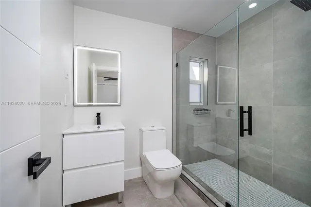 a bathroom with a toilet sink and shower